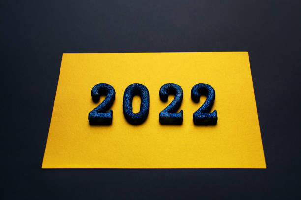 istock 2022 digits on golden background as a New Year concept 1356119478