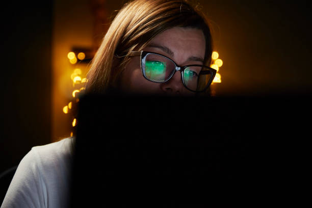 istock Tired woman works late at home workplace 1356120166