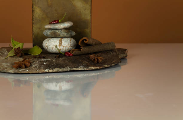 Different kind of spices on stone on white table against brown background