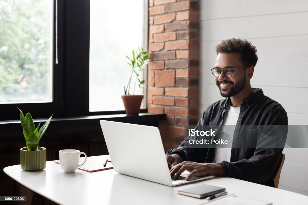 Young man working from home. Creative professional have meeting online Businessman using laptop computer in office. Student studying online. Entrepreneur, creative occupation, work from home, freelance, online learning, studying concept. Distance education Men Stock Photo