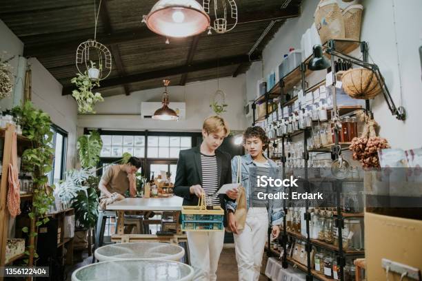 Gay Couple Looking Around In Zerowaste Storestock Photo Stock Photo - Download Image Now