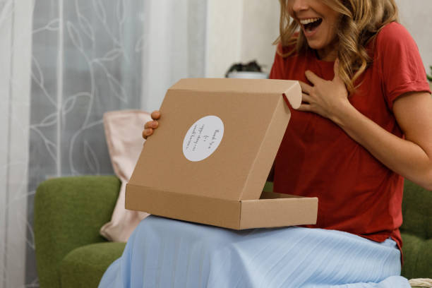 istock Woman excited when getting a first peek at the package she opened 1356123695