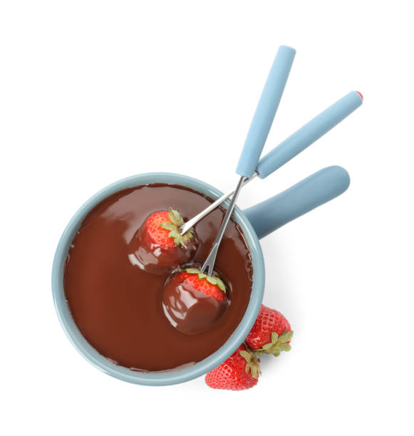 istock Fondue pot with chocolate and fresh strawberries isolated on white, top view 1356124036