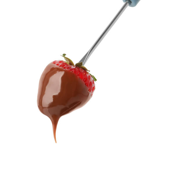 istock Strawberry with chocolate on fondue fork against white background 1356124040