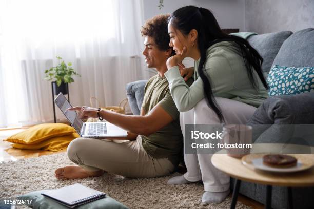 Millennial Couple Looking At Their Finances Via Online Banking Stock Photo - Download Image Now