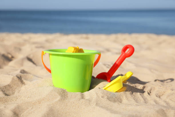 istock Bright child plastic toys on sandy beach 1356124137