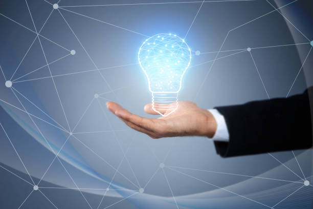 istock Idea concept. Businessman demonstrating glowing light bulb illustration on grey background, closeup 1356124723