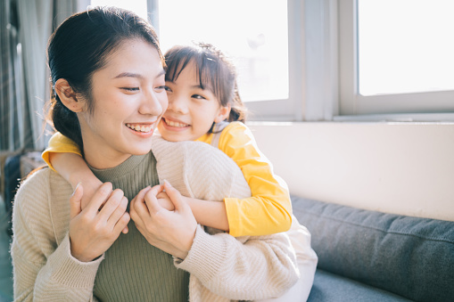 Asian mother and daughter at home together