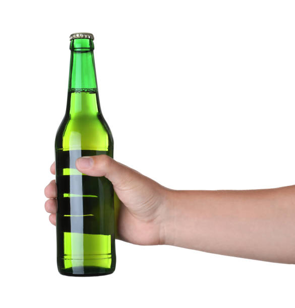 istock Man holding green bottle with beer on white background, closeup 1356124834