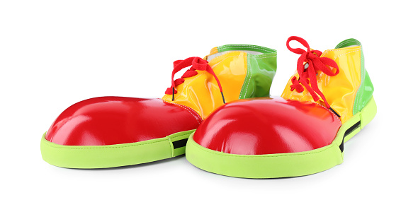 Funny colorful clown shoes with red laces isolated on white