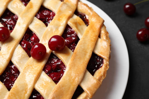 istock Delicious pie with cherries on black table, closeup 1356125151