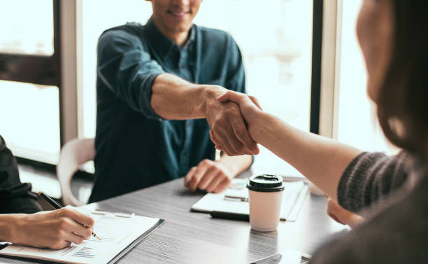 close up. young businessman shaking hands with his business partner stock photo