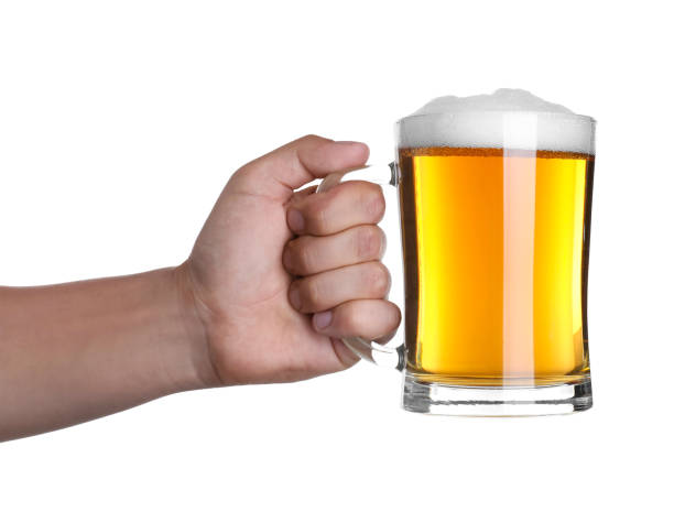 istock Man holding glass mug with beer on white background, closeup 1356125355