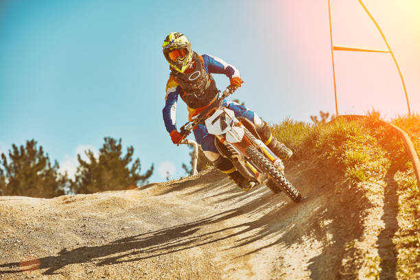 Extreme motorcycle race. Biker rides off-road on a motorcycle for extreme racing. Special processing under the film with flare stock photo
