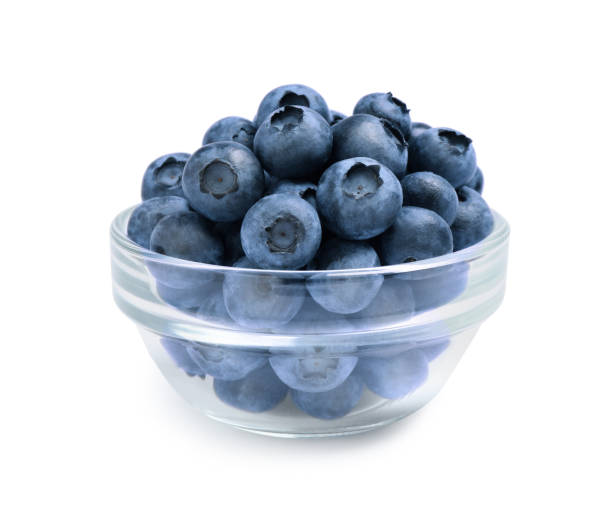 istock Fresh ripe blueberries in glass bowl on white background 1356126430