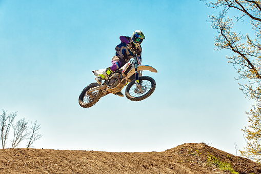 A shot of a motocross rider in air during a race