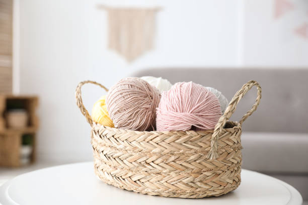istock Wicker basket with clews on table indoors. Engaging in hobby 1356127829