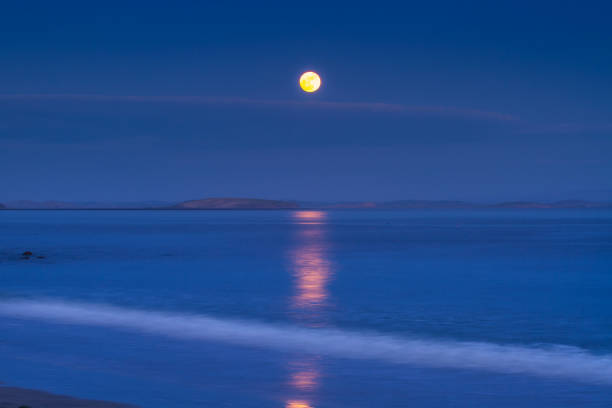 istock Red full moon reflected in the Atlantic ocean 1356127950