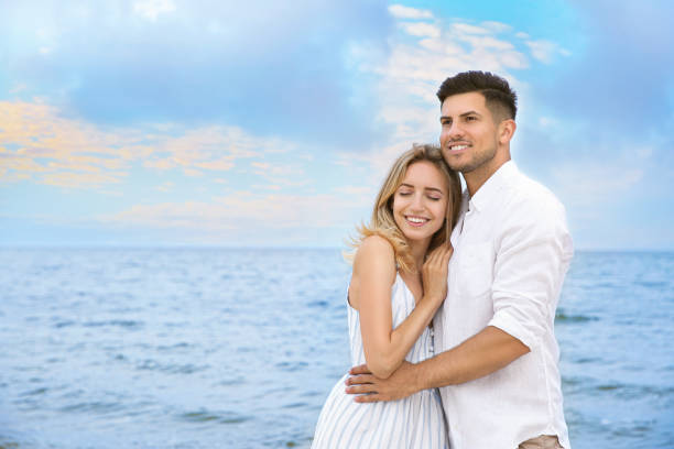 istock Happy couple on beach, space for text. Romantic walk 1356128520