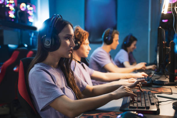 istock Gamers in gaming headsets playing in strategy video games on the computers 1356129471