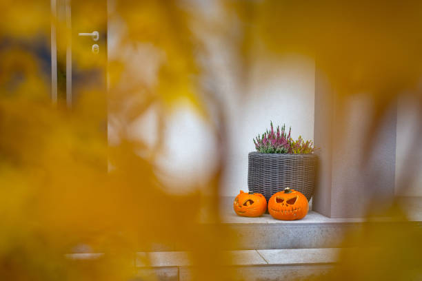 Scary Halloween pumpkins as decoration Scary Halloween pumpkins as decoration on the front steps entrence stock pictures, royalty-free photos & images