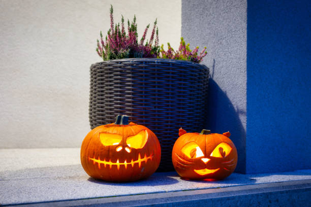 Scary Halloween pumpkins as decoration Scary Halloween pumpkins as decoration on the front steps entrence stock pictures, royalty-free photos & images