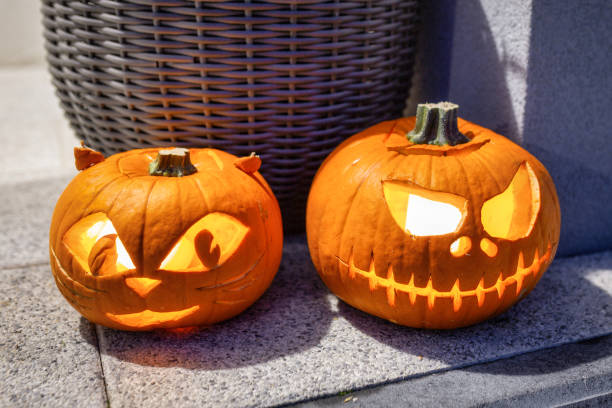 Scary Halloween pumpkins as decoration Scary Halloween pumpkins as decoration on the front steps entrence stock pictures, royalty-free photos & images