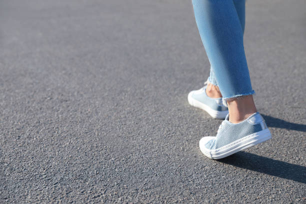 istock Woman walking outdoors, closeup with space for text. Choosing way concept. 1356131463