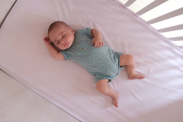 Caucasian baby sleeping Caucasian baby sleeping peacefully in his crib crib stock pictures, royalty-free photos & images
