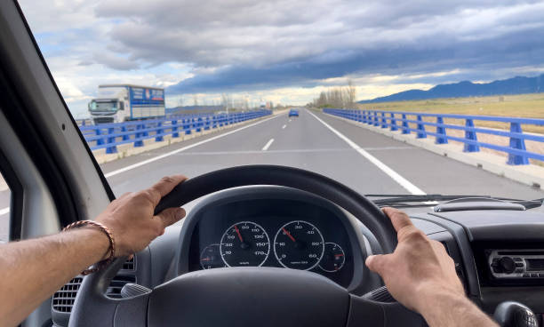 istock driving a car view on the road 1356132904