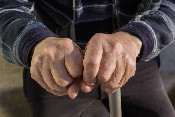 istock Hands of an elderly man leaning on his walking stick 1356135031