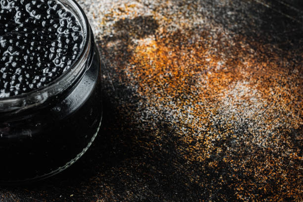 istock Black sturgeon caviar, on old dark rustic background  with copy space for text 1356135964
