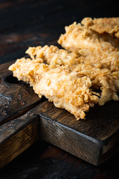 istock Crispy chicken tenders on dark wooden background 1356137611