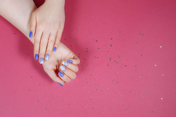 istock christmas blue manicure on a pink background 1356137666