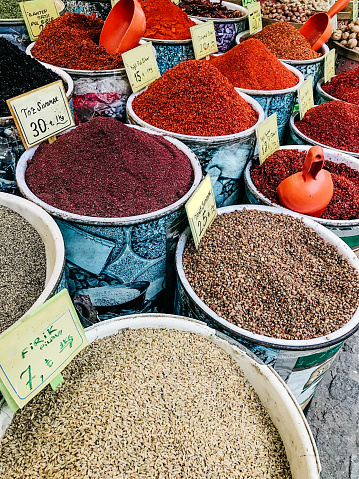 Vertical image of colorful spices and legumes for sale in a street market. Concept of street market.