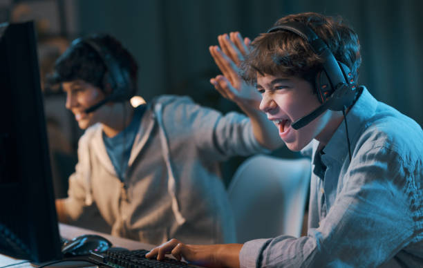 Friends playing online video games and winning stock photo