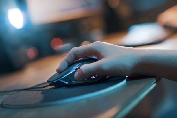 istock Gamer hand on the mouse close up 1356139272