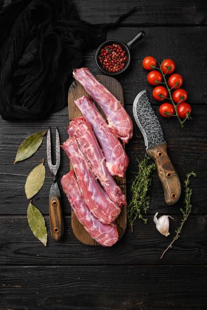 istock Raw uncooked chicken gizzards, on black wooden table background, top view flat lay 1356139281