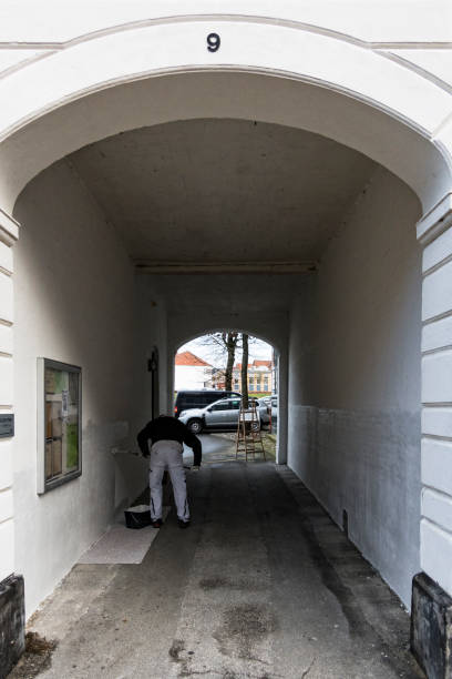 Hjorring, Denmark Hjorring, Denmark Nov 24, 2021 A man paints an archway  in the downtown hjorring stock pictures, royalty-free photos & images