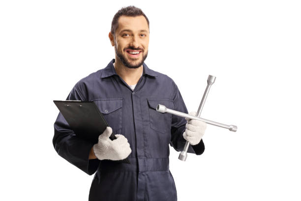 istock Auto mechanic holding a clipboard and a lug wrench 1356140415