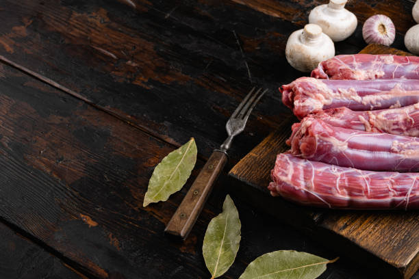 istock Raw duck neck, on old dark  wooden table background, top view flat lay, with copy space for text 1356140629