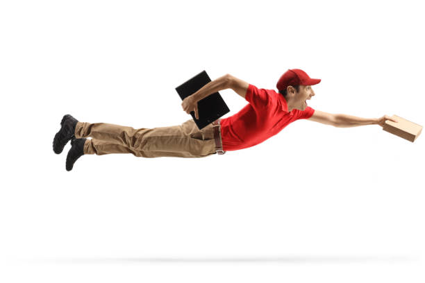 istock Delivery man flying and delivering a package 1356141710