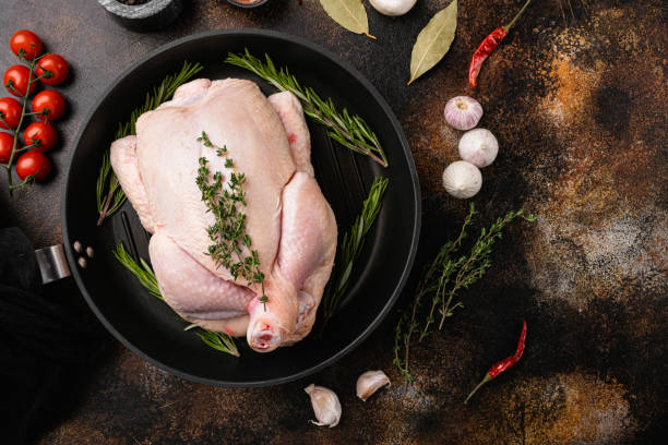 istock Organic raw whole chicken, on old dark rustic table background, top view flat lay, with copy space for text 1356141838