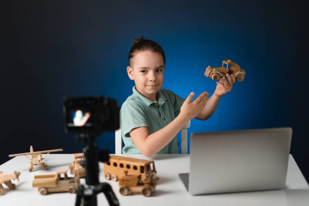 istock Young boy video blogger making stream with his followers. 1356144241