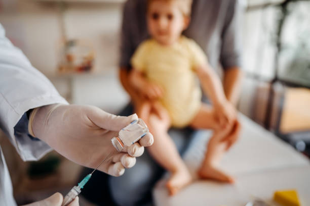 istock Doctor preparing vaccine for baby boy 1356144329