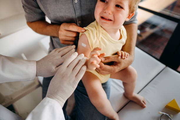 istock Little baby crying after vaccination 1356144481
