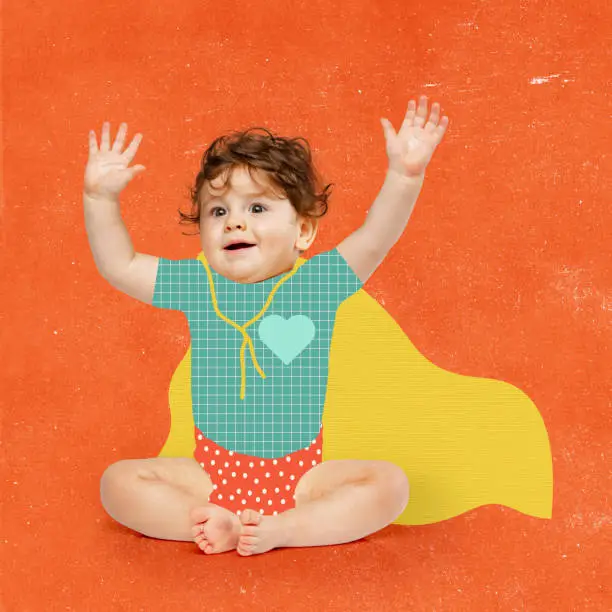 Photo of Contemporary art collage of playful little boy in character of superman in drawn cloak isolated over orange background