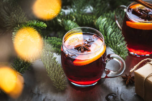 Close up of a glass of mulled wine, fir branches and fairy lights Drink, christmas, advent, alcohol, cooked hot, gray, table, cinnamon mulled wine stock pictures, royalty-free photos & images