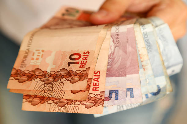 istock money several bills in one hand 1356147714