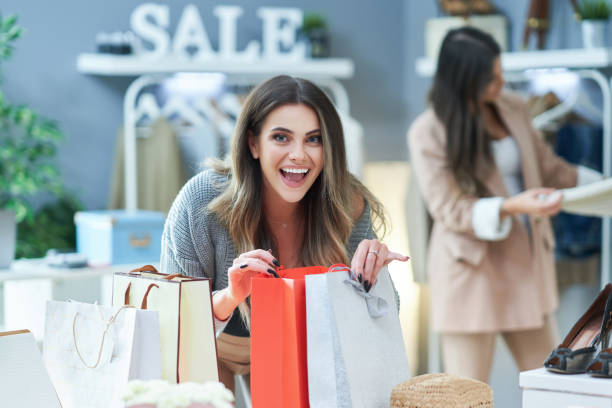 istock Group of happy friends during shopping 1356147833